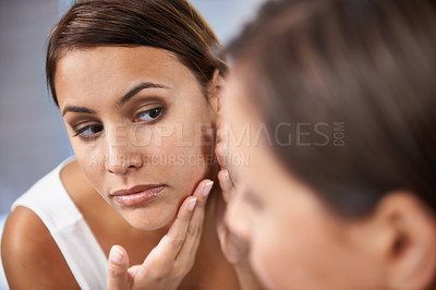 Buy stock photo Pores, woman and skincare in mirror with face spot or pimple or acne on cheek. Female person, pointing and serious with reflection in bathroom for skin and self care as daily routine for treatment
