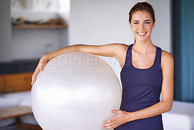 Buy stock photo Portrait of an attractive and sporty young woman holding a pilates ball