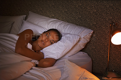 Buy stock photo Shot of an attractive young female sleeping in the dark