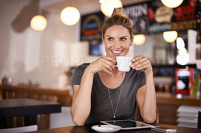 Buy stock photo A beautiful young woman drinking coffee at a coffee shop
