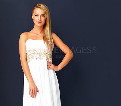 Buy stock photo Portrait of stunning young model posing in evening gown on black background