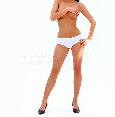 Buy stock photo Sexy attractive young woman standing in white underwear with hands covering breast isolated on white background