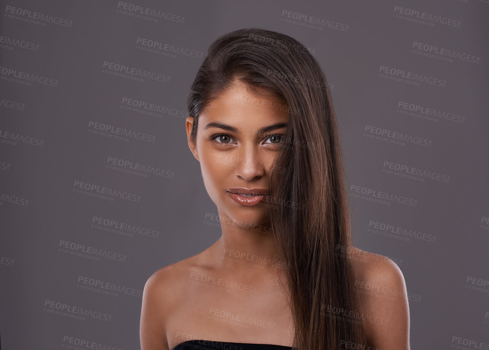 Buy stock photo Portrait, hair care and beauty of woman in makeup, glow or shine isolated on gray studio background. Face, hairstyle and Indian model in cosmetics at salon for skincare at hairdresser on mockup space