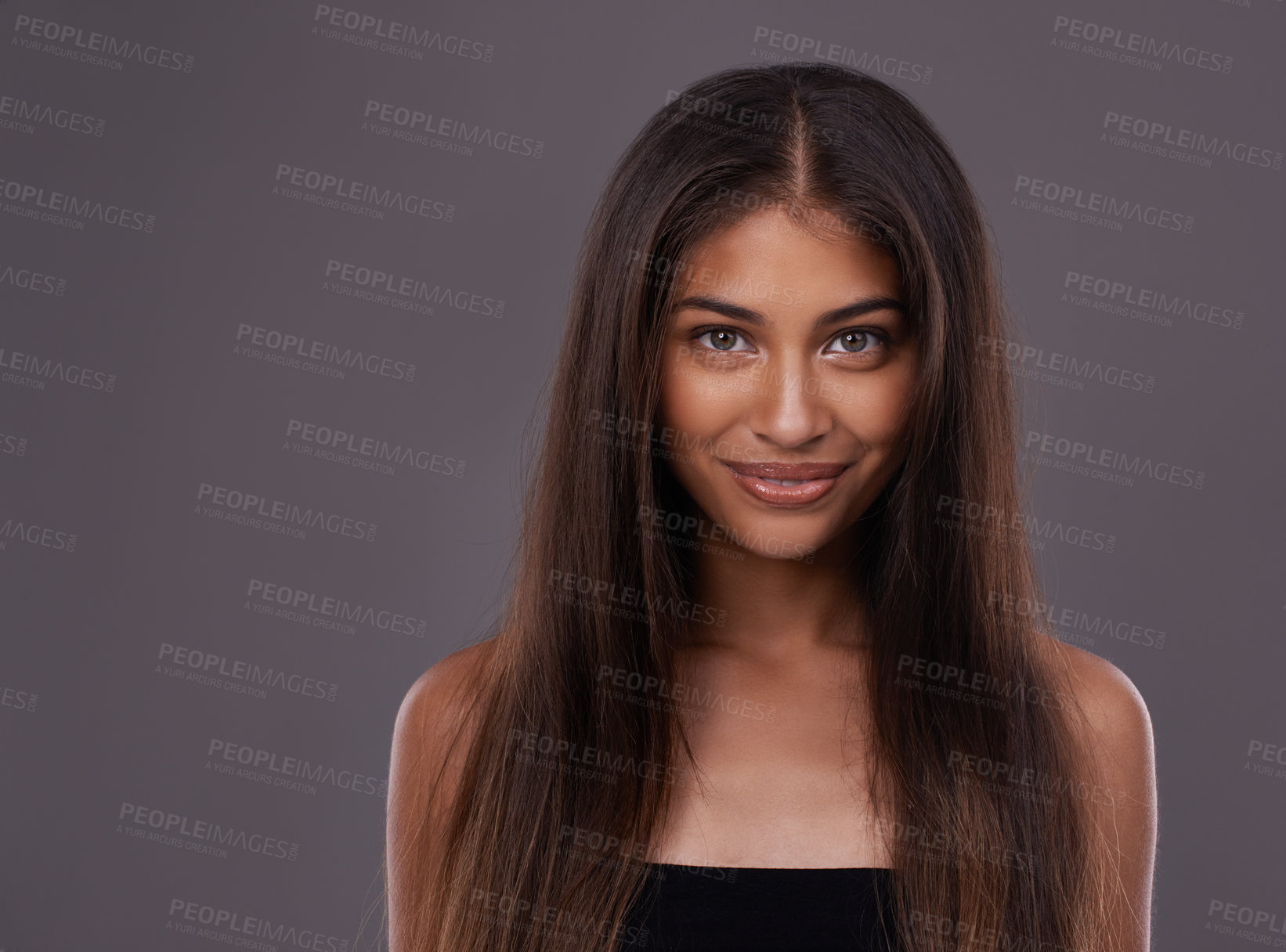 Buy stock photo Portrait, hair care and Indian woman with cosmetics, treatment and grooming routine on a grey studio background. Face, person and model with volume or texture with keratin and healthy shine with glow
