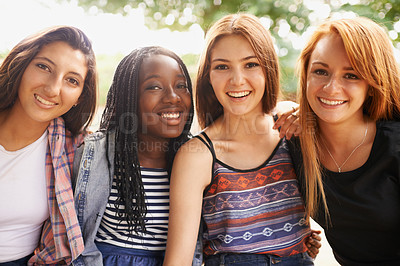 Buy stock photo Four beautiful young girls smiling happinly while they sit outside