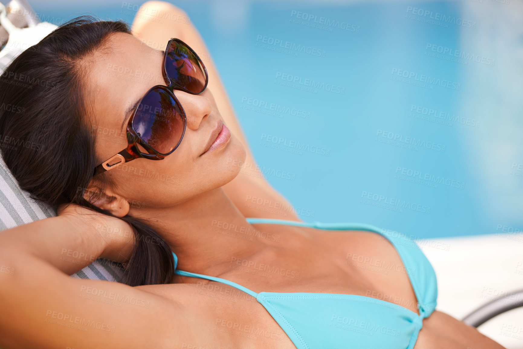 Buy stock photo Woman, bikini or tanning at swimming pool to relax, rest or chill in summer holiday vacation in Hawaii. Calm girl, break and zen female person sunbathing in a spa at resort, home or hotel for peace