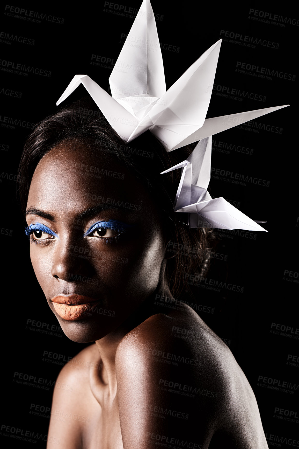 Buy stock photo Studio, beauty and cosmetics for black woman with makeup in dark background with aesthetic for luxury. Eyeshadow, glow and foundation on face of girl for shine, African female person and origami