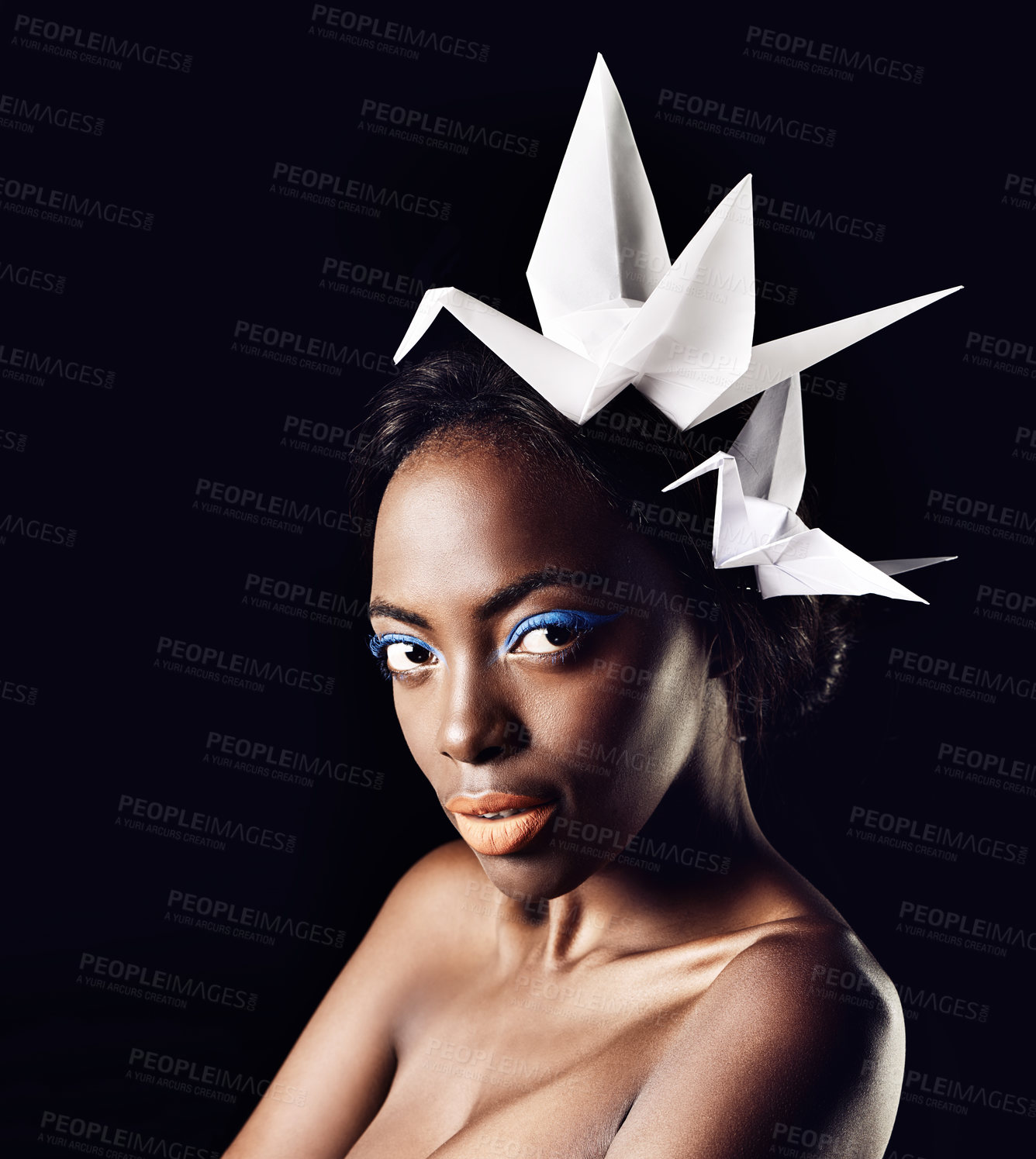 Buy stock photo Cosmetics, portrait and black woman in studio with origami birds for honor with glamour aesthetic. Dark background, female person and African girl with makeup, glow and shine for natural beauty