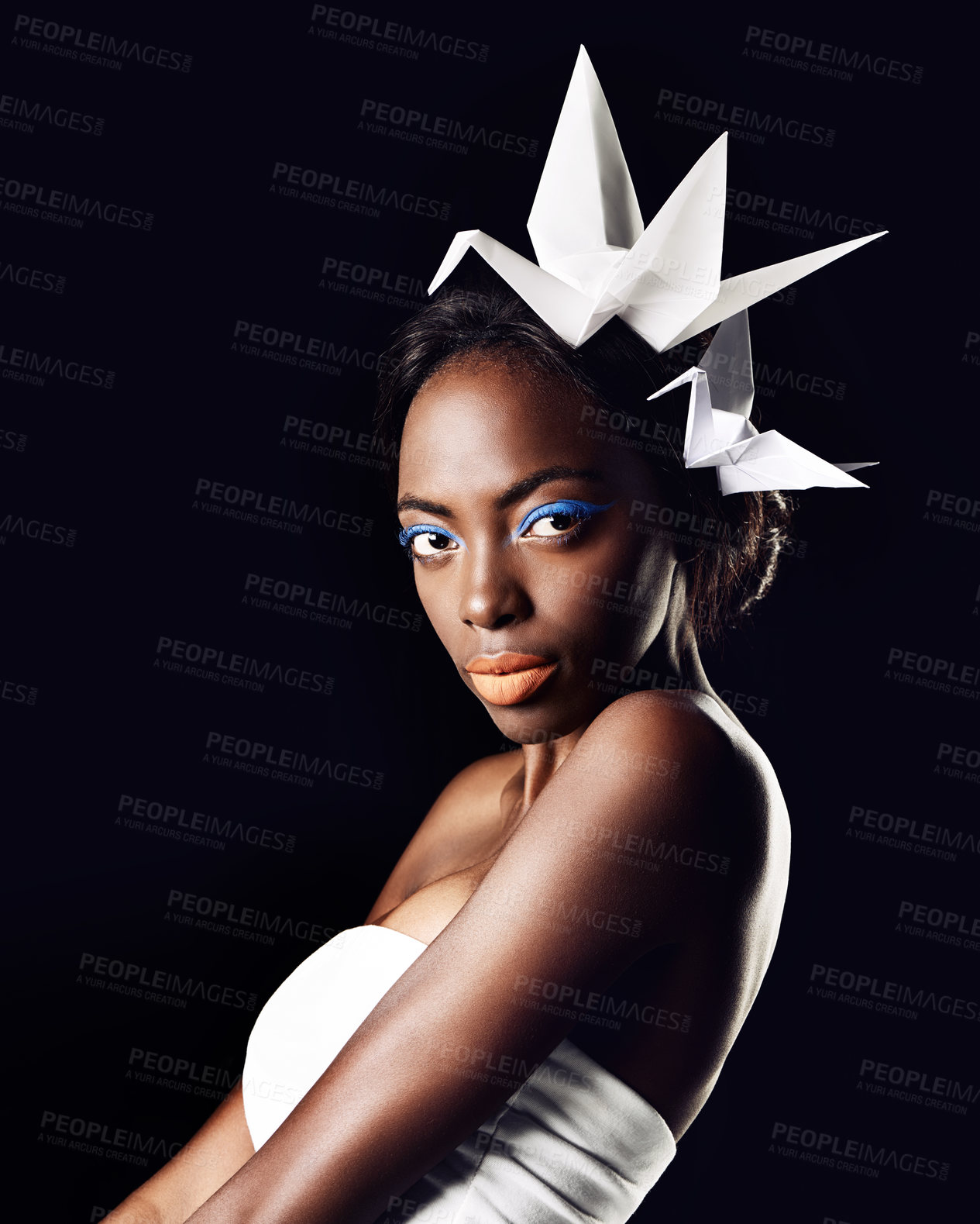 Buy stock photo Studio, portrait and natural cosmetics for black woman in dark background with aesthetic for honor. Eyeshadow, glow and foundation on face of girl for shine, African female person and origami birds