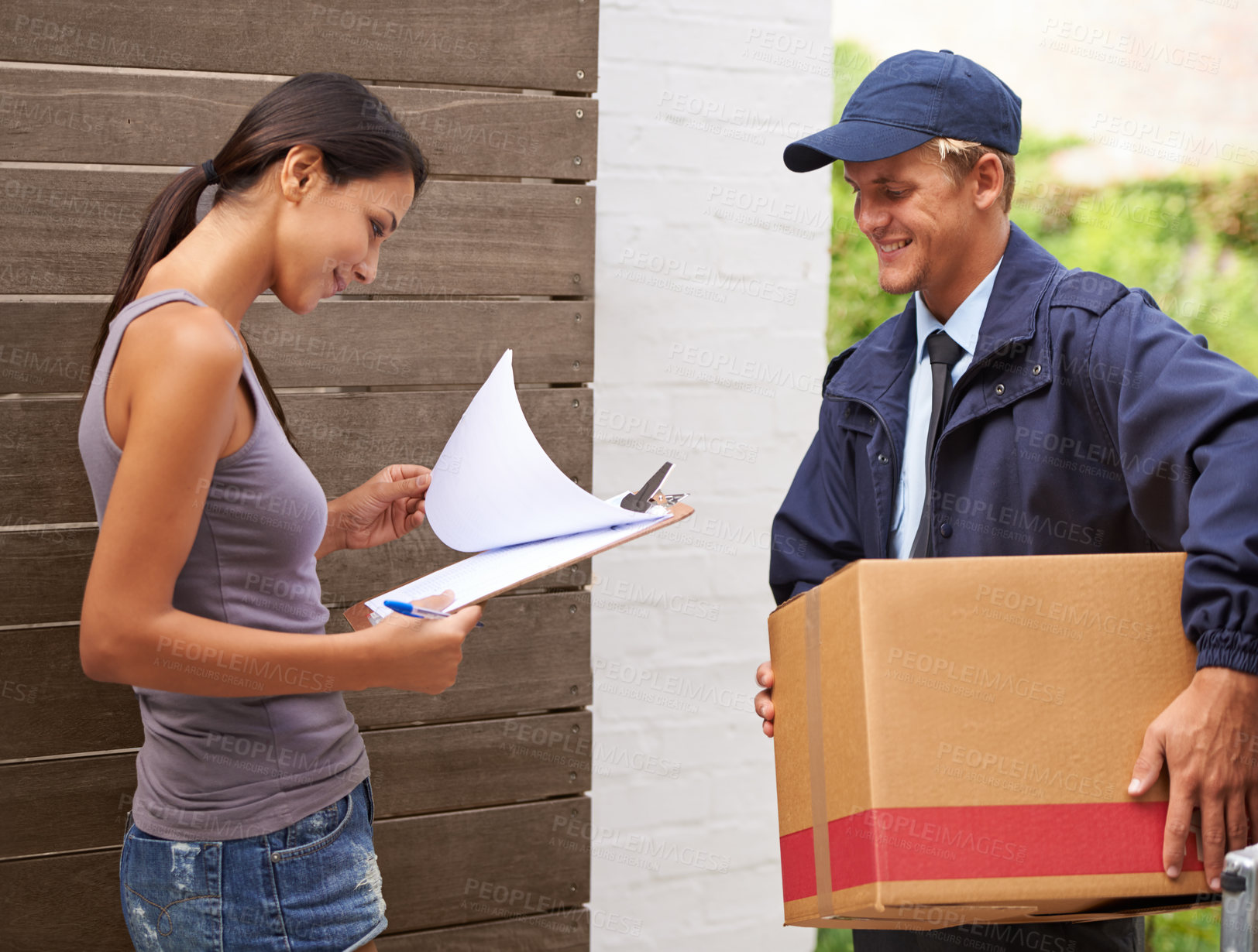 Buy stock photo Cropped shot of a beautiful woman receiving a delivery