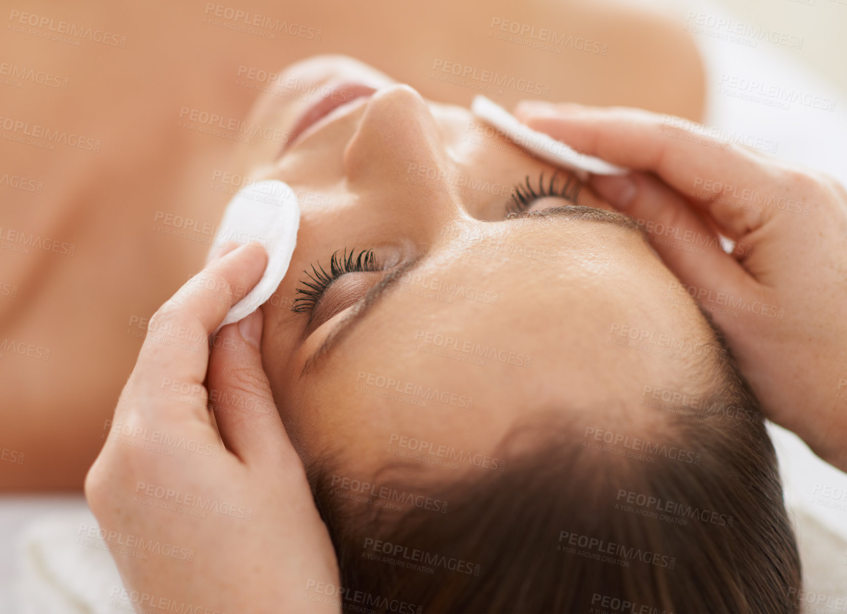 Buy stock photo Woman, cotton and facial massage for organic treatment to relax, cosmetics and beauty therapy for skin care. Female person, calm and serene or dermatology, closeup and rest at hotel and peace or zen