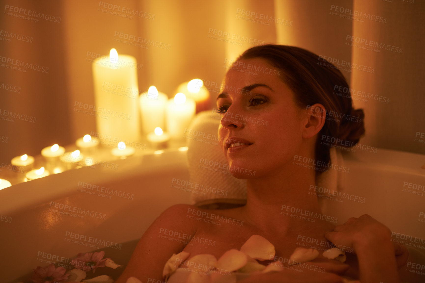 Buy stock photo Cropped shot of a gorgeous woman relaxing in a candle lit bath