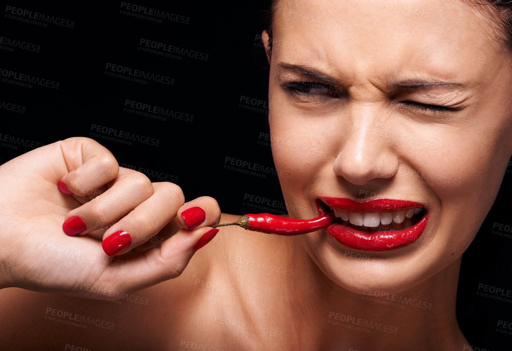 Buy stock photo Beauty, makeup and woman eating chilli in studio with manicure on hand isolated on a black background. Cosmetics, model and person with pepper in mouth, food or healthy vegetable for skincare on face