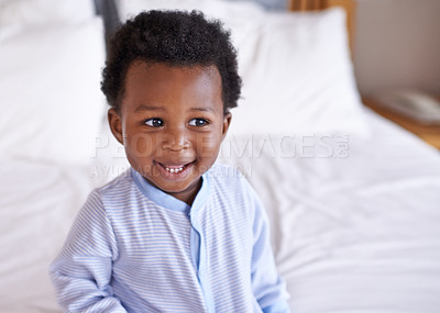 Buy stock photo Happy, curious and baby laughing in bed, waking up and playing in his home. Face, smile and african boy toddler in a bedroom cheerful, having fun and sweet, cute and playful  while relaxing alone 