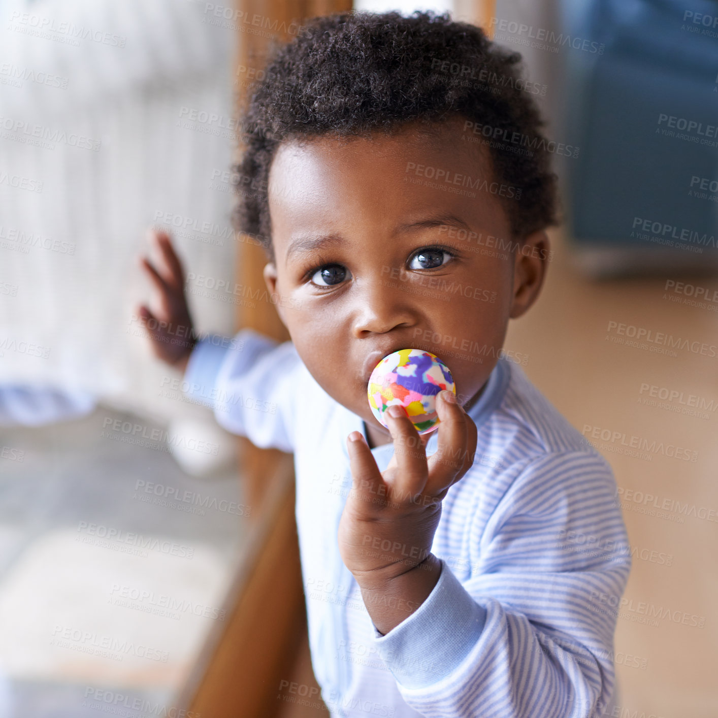 Buy stock photo Portrait, baby or toy in play, coordination or growth as learning, game or progress in Jamaica. Black boy, child or ball in mouth as healthy, motor skill or fun in curious, cognitive or sensory