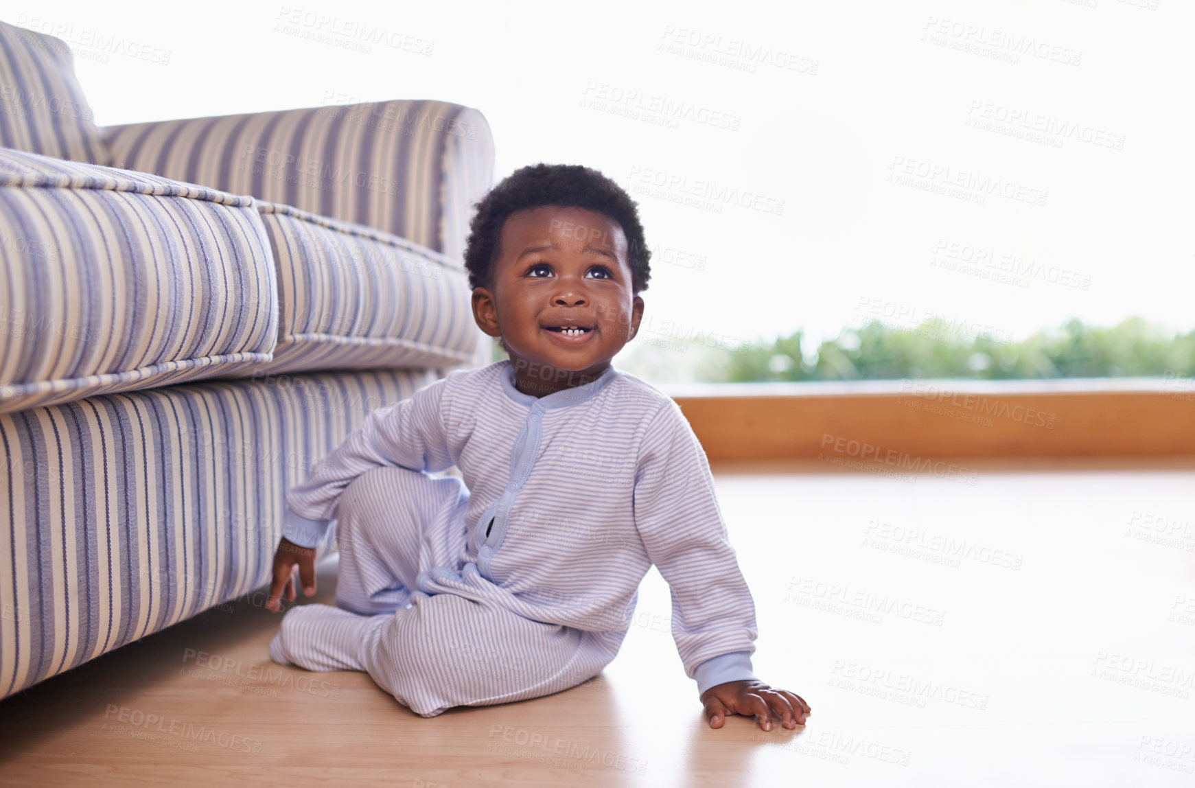 Buy stock photo Black baby boy sitting on floor in living room, childhood development with growing happy kid at family home. African male toddler, cute child relax on wood floor with growth and learning mobility