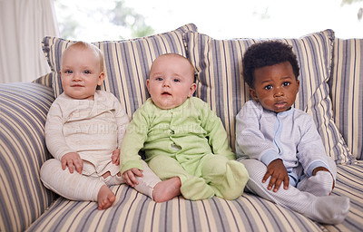 Buy stock photo Portrait of three adorable babies sitting on a couch