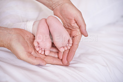 Buy stock photo Baby, feet and hands for childcare on bed or development with parenting trust with support, love or connection. Kid, foot and fingers in palm for wellness bonding in apartment, protection or security