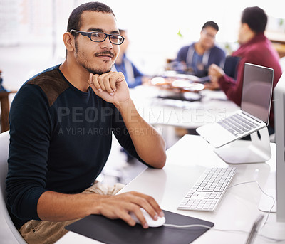Buy stock photo Cropped shot of a young man working on his laptop in an office