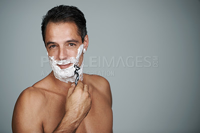 Buy stock photo Man, portrait and shaving cream with razor for skincare treatment with hair removal, studio or grey background. Male person, beard and lotion with tool for grooming for cleaning, hygiene or mockup