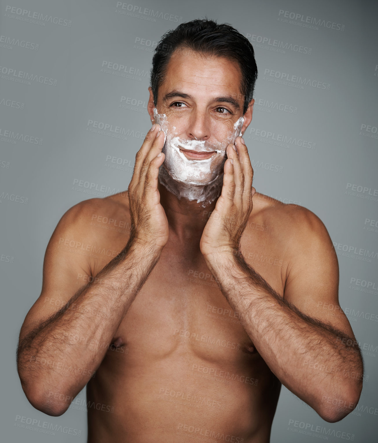 Buy stock photo Man, shaving and foam for beard skincare or after shave with hair removal product, transformation or grey background. Male person, hands and studio wellness or face application, grooming or mockup