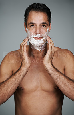 Buy stock photo Man, portrait and shaving cream skincare on beard or after shave with hair removal product, transformation or grey background. Male person, hands and studio or face application, grooming or mockup