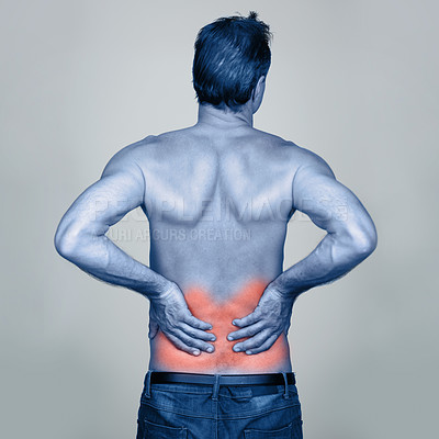 Buy stock photo Medical, back pain and man with injury in studio with inflammation, discomfort or muscle sprain. Red glow, shirtless and person with healthcare emergency, ache or strain isolated by gray background.