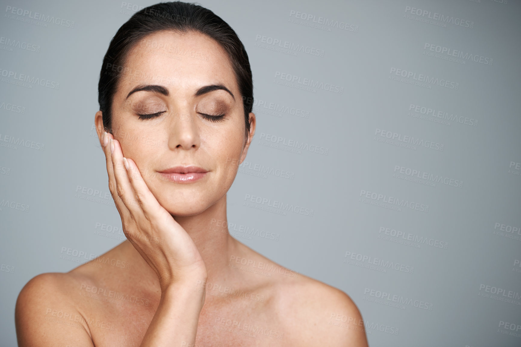 Buy stock photo Mature, skincare and woman touching face with makeup at studio isolated on gray background mockup. Cosmetics, beauty and hand of model in facial treatment for dermatology, anti aging and eyes closed