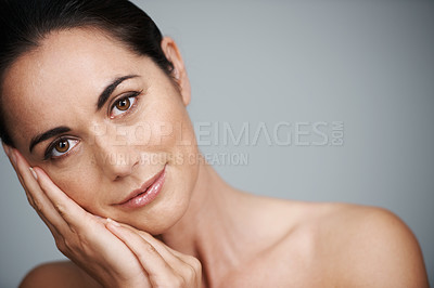 Buy stock photo Cropped studio shot of a beautiful mid adult woman touching her face