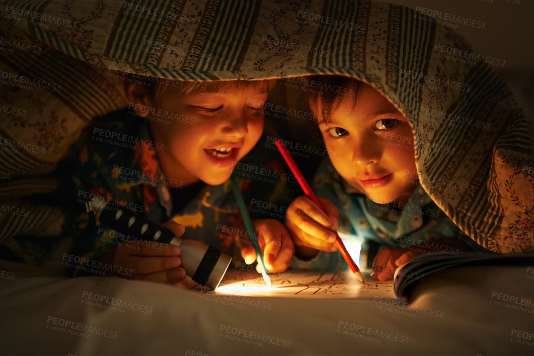 Buy stock photo Blanket, flashlight and children at night with happiness in portrait with drawing in a book. Friends, relax and sketch on notebook in dark with light under duvet at sleepover with a pillow tent