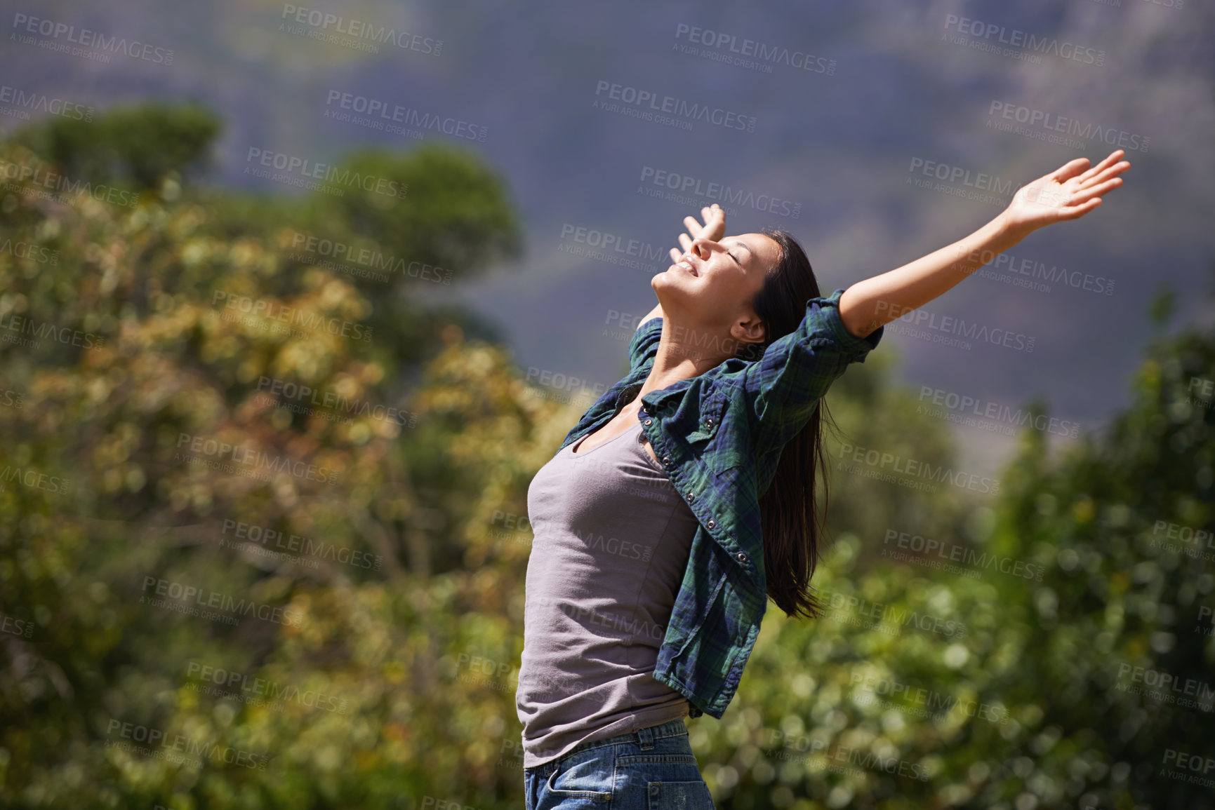 Buy stock photo Freedom, joy and relax for woman in outdoor, garden or forest for bliss, satisfaction and fulfillment. Young person, smile with arm in air for optimism, happiness and excited in environment on mockup