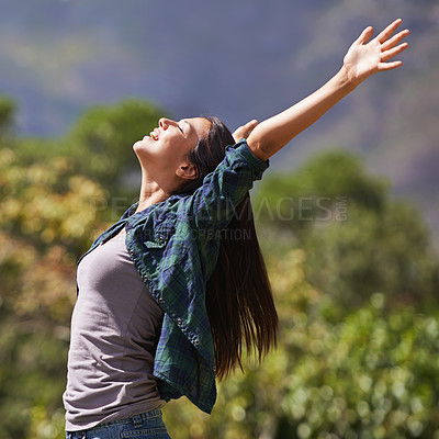 Buy stock photo Freedom, peace and hands raised with young woman in garden of spring for enthusiasm or inspiration. Nature, smile and wellness with happy person outdoor at park in summer for energy or excitement