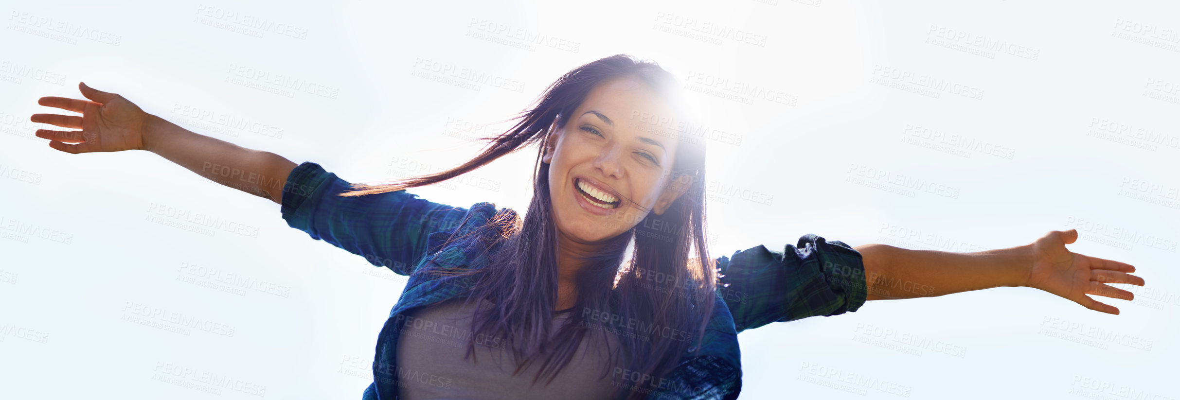 Buy stock photo Portrait, sky and open arms with a woman outdoor in nature to celebrate a life of financial freedom in summer from below. Smile, banner and wellness with a happy young female person with lens flare