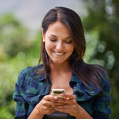 Buy stock photo Smile, phone and woman in nature networking on social media, mobile app or internet for communication. Happy, technology and young female person scroll on cellphone in outdoor garden, field or park.