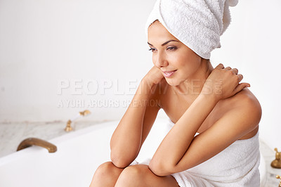 Buy stock photo Shot of a beautiful young woman relaxing in the bathroom in a towel