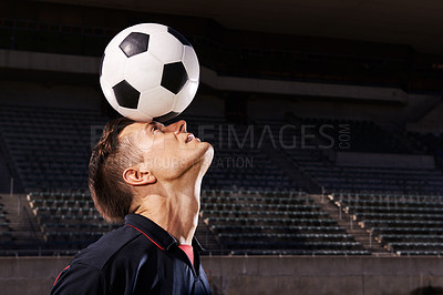 Buy stock photo Shot of a young footballer balancing a ball on his head