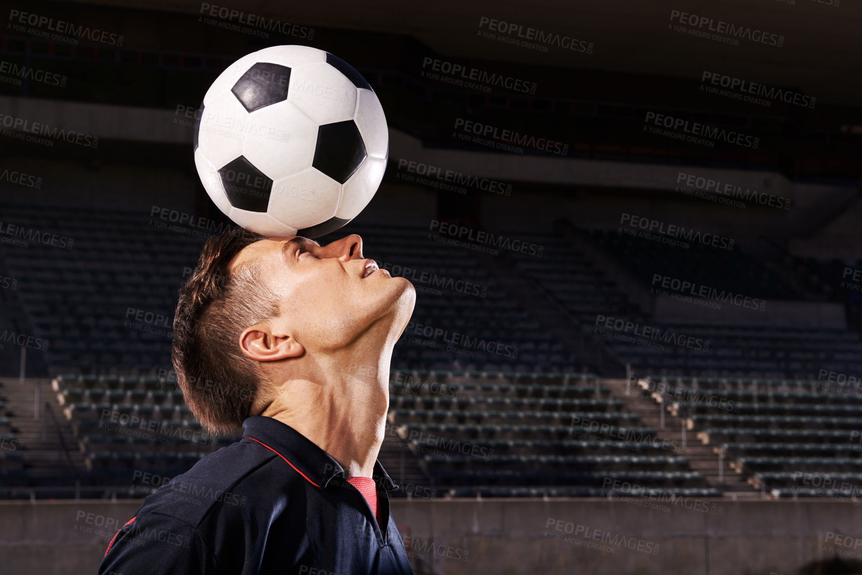 Buy stock photo Shot of a young footballer balancing a ball on his head