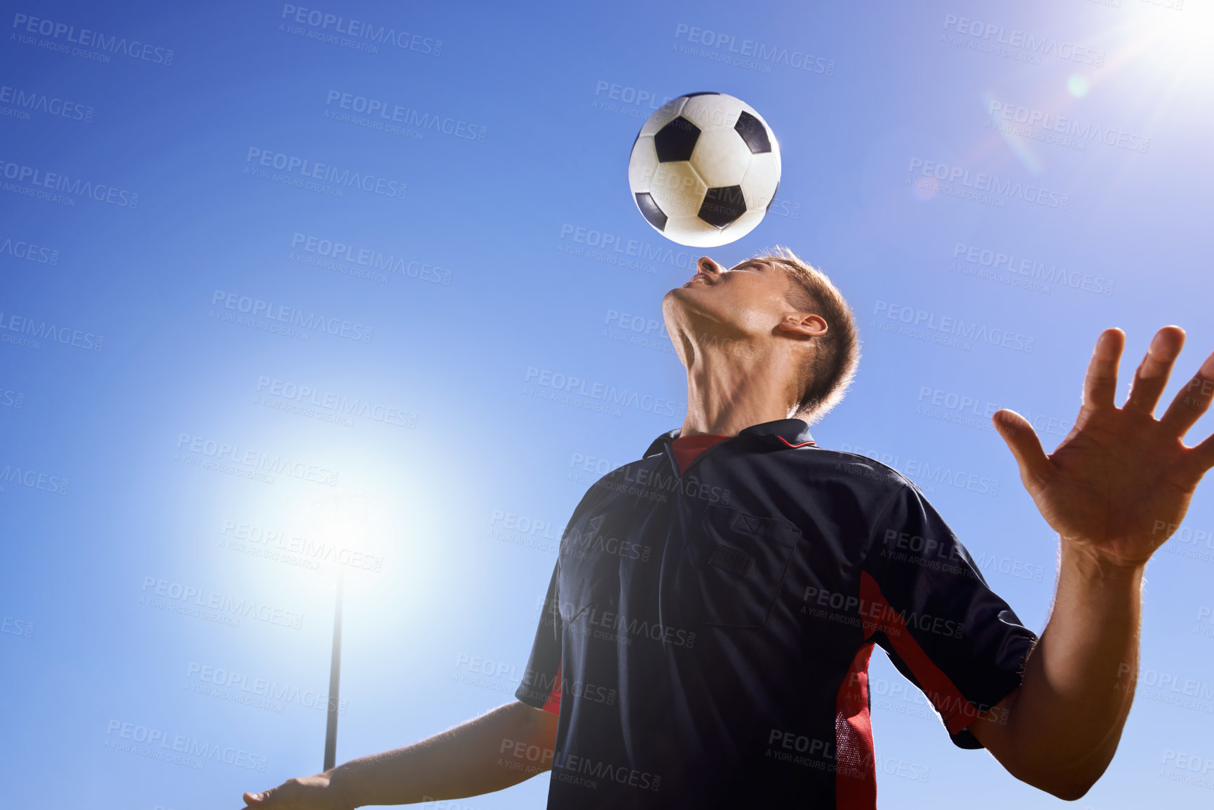 Buy stock photo Football, bounce and head with man, game and training with competition, sunshine and exercise. Blue sky, lens flare and player with practice or athlete with skills or technique with fitness or soccer