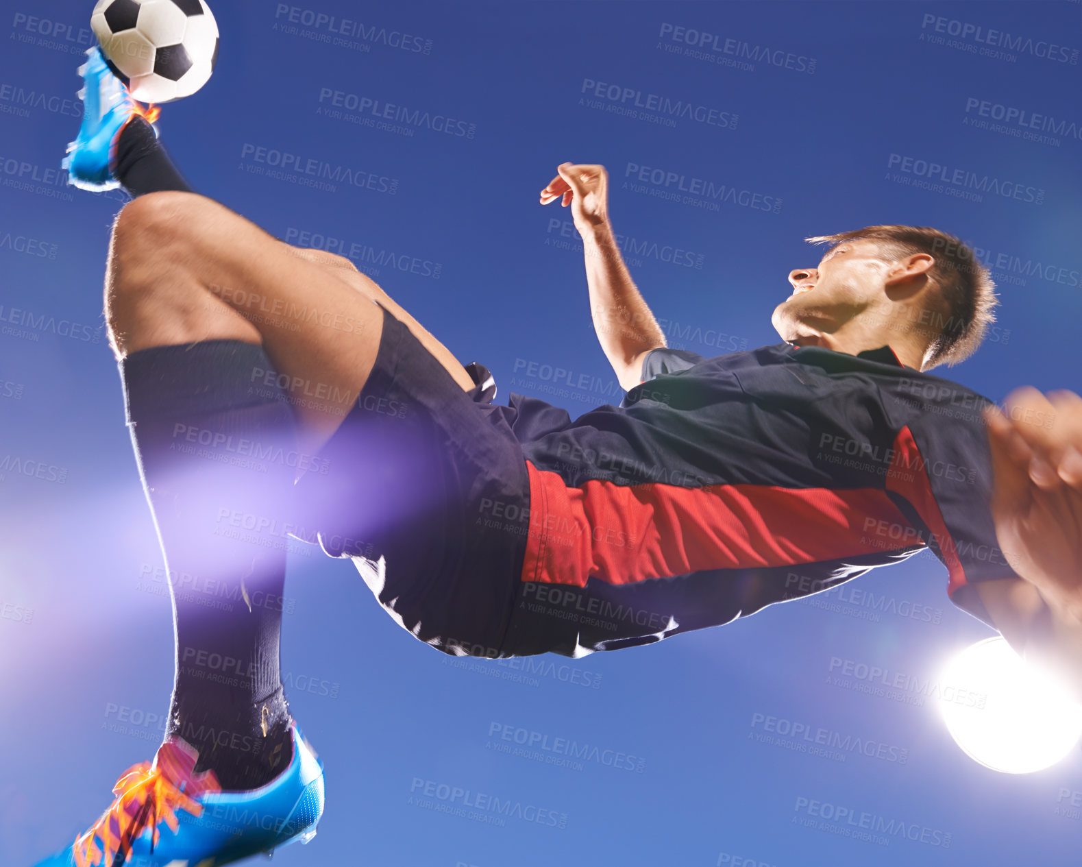 Buy stock photo Football player, jump and kick with man and soccer ball, energy and challenge with skill in professional sport. Sky background, light and playing game at arena or stadium, action and exercise outdoor