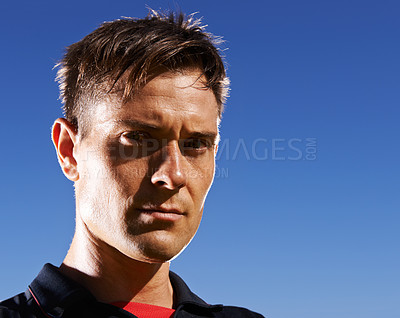 Buy stock photo Portrait, man and athlete serious outdoor, sky background for fresh air with football player at stadium. Determined face, confident and pride in headshot with professional sportsman at training