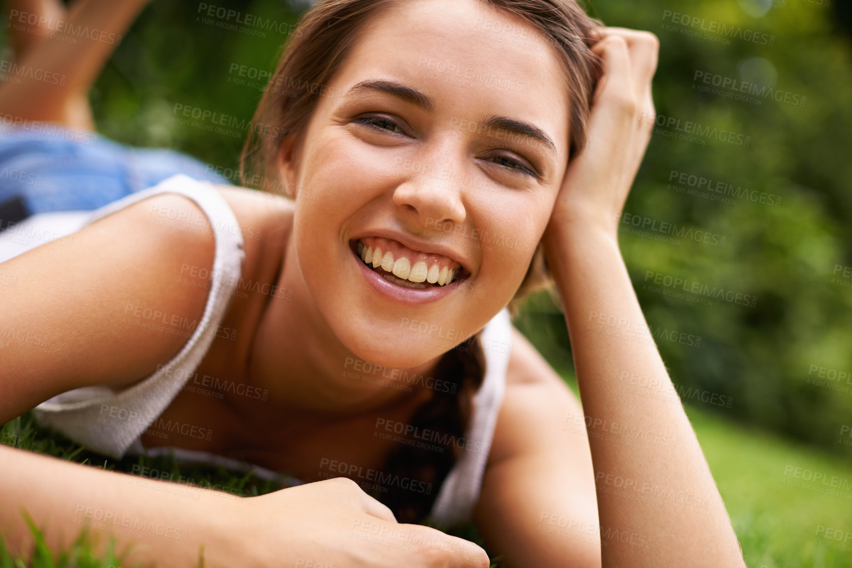 Buy stock photo Woman, portrait and laughing on grass for relax with sunshine, enjoyment or weekend break in summer. Young person, funny and confident on lawn, garden or backyard of home for fresh air in environment