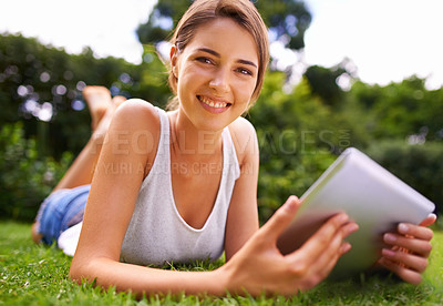 Buy stock photo Portrait of an attractive young woman lying on the grass