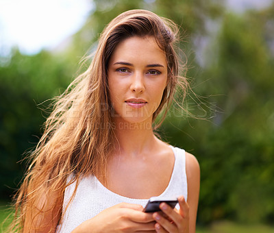 Buy stock photo Phone, nature and portrait of woman in park networking on social media, app or internet. Serious, technology and young female person scroll on cellphone for communication in outdoor field or garden.