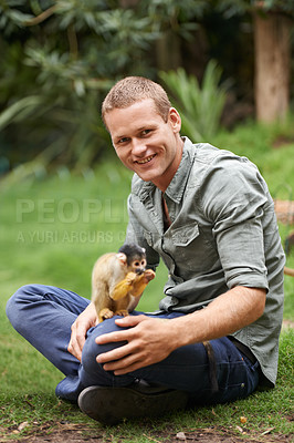 Buy stock photo Animal, man and portrait with monkey for wildlife rescue, outdoor activity or interactive experience in nature. Conservation, zoo and happy male person for bonding, holiday and travel at sanctuary