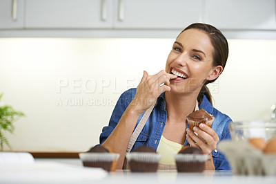 Buy stock photo Portrait, cupcake and kitchen with woman, eating or confidence with cooking or ingredients. Face, person or home with baker, treat or girl with dessert or sweet with food or cheerful with sugar snack