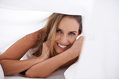 Buy stock photo Portrait of a beautiful young woman enjoying a morning in bed