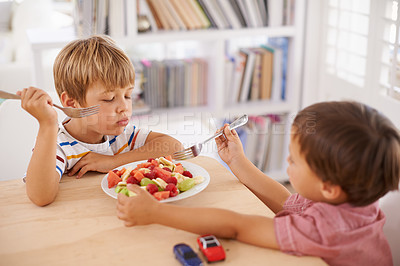 Buy stock photo Children, boys and eating fruit salad for lunch in dining room for nutrition, healthy meal and wellness in home. Siblings, kids and breakfast bowl with watermelon, grapes and berries for sharing