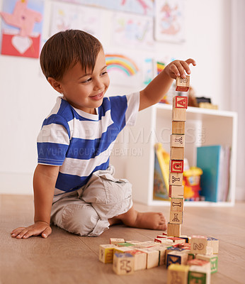 Buy stock photo Home, boy or child with building blocks for playing and learning for development or growth in playroom. Happiness, education and playful with activity, young toddler kid and fun games for creativity 