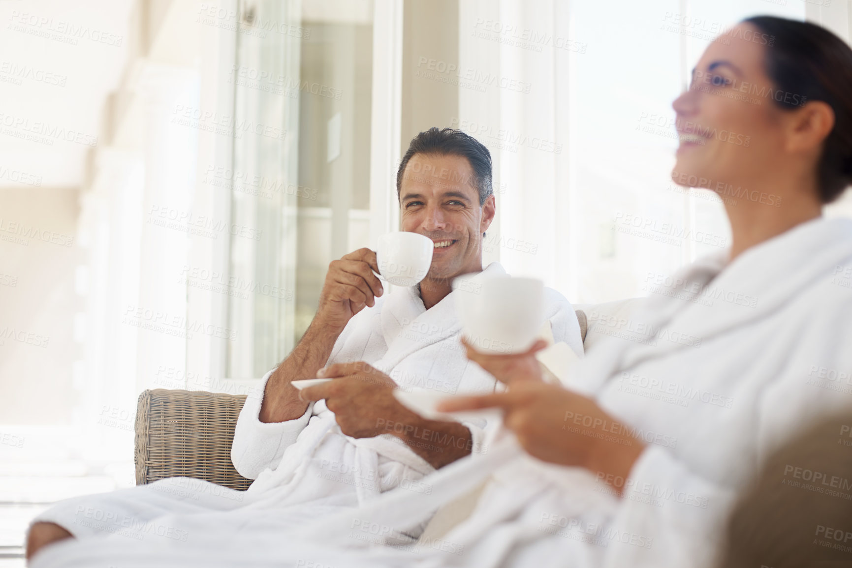 Buy stock photo Laugh, coffee and smile with couple at spa for luxury, vacation and romance. Breakfast, peace and morning with happy man and woman at hotel resort for wellness, celebration and holiday travel