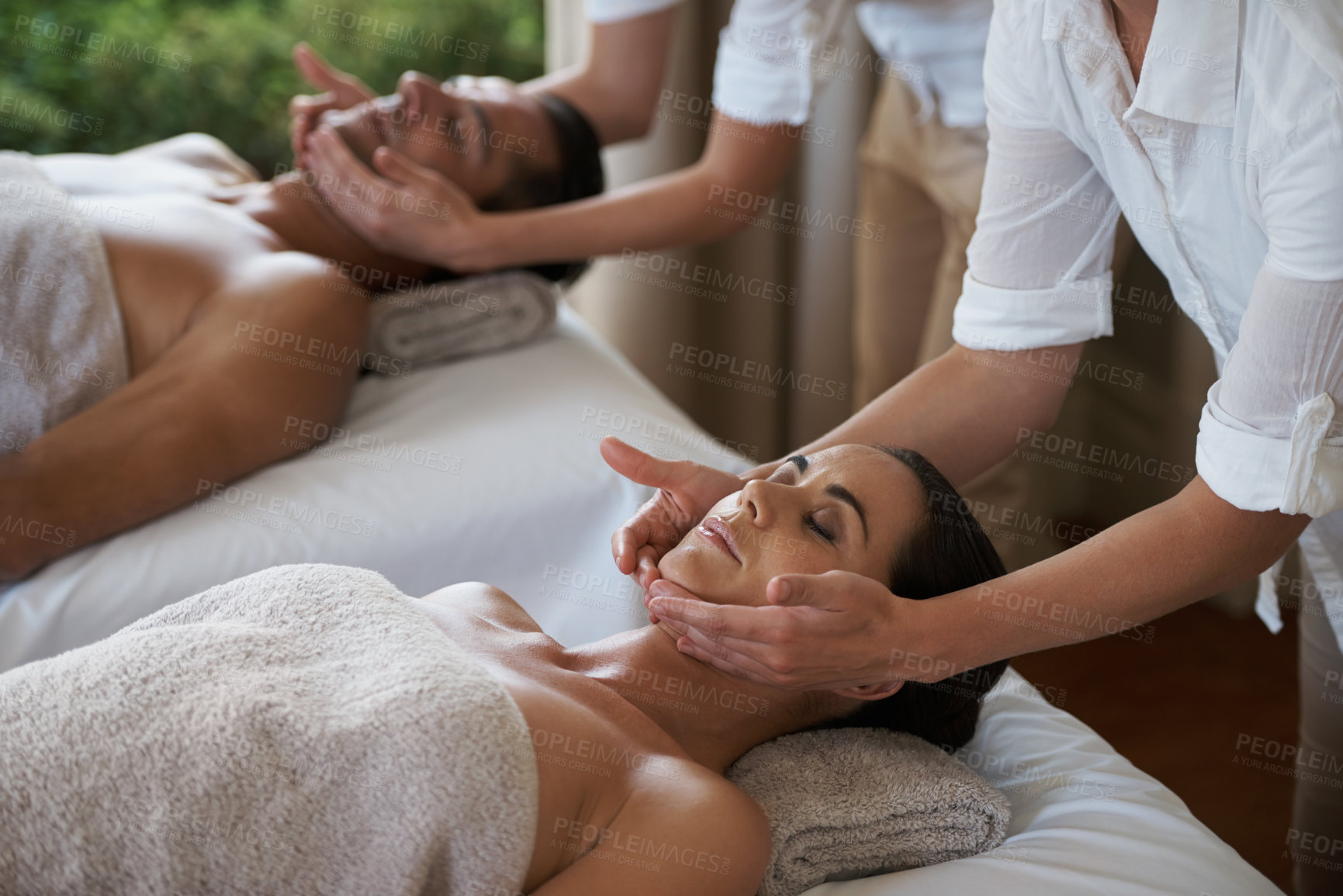 Buy stock photo Vacation, facial massage and couple relax in spa for care of body with rest on table of retreat for honeymoon. Hotel, man and woman together in resort for health, wellness and holiday for skincare